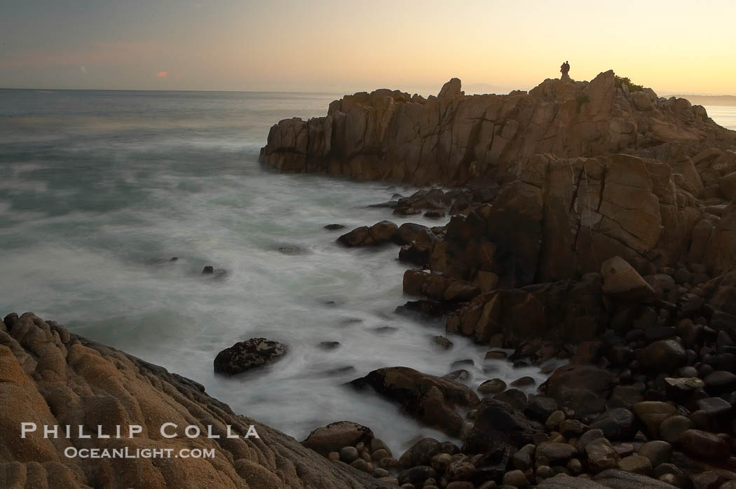 Lovers Point, Pacific Grove.  A couple admires the sunrise atop Lovers Point in Pacific Grove.  Waves breaking over rocks appear as a foggy mist in this time exposure.  Pacific Grove., natural history stock photograph, photo id 14918
