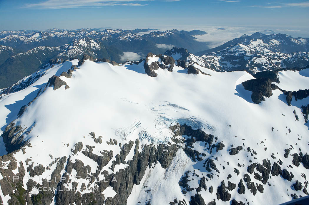 Mariner Mountain, on the west coast of Vancouver Island, British Columbia, Canada, part of Strathcona Provincial Park, located 36 km (22 mi) north of Tofino.  It is 1,771 m (5,810 ft) high, snow covered year-round and home to several glaciers., natural history stock photograph, photo id 21072