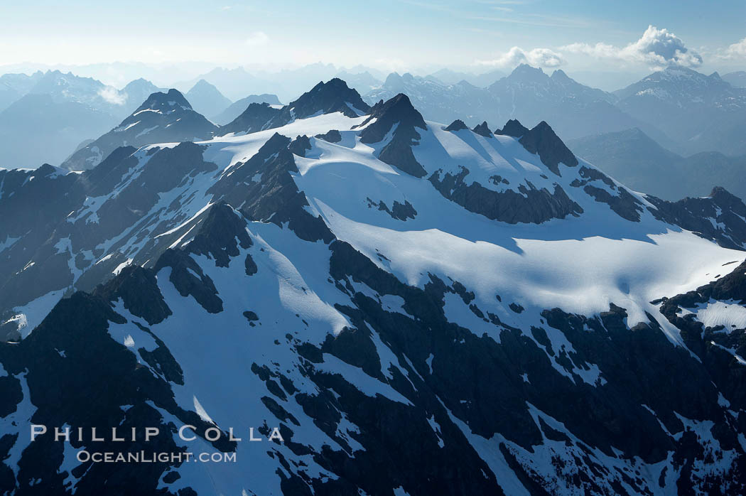 Mariner Mountain, on the west coast of Vancouver Island, British Columbia, Canada, part of Strathcona Provincial Park, located 36 km (22 mi) north of Tofino.  It is 1,771 m (5,810 ft) high, snow covered year-round and home to several glaciers., natural history stock photograph, photo id 21092