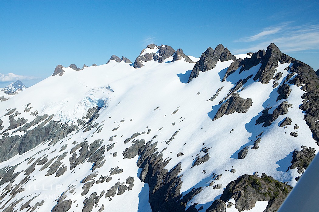 Mariner Mountain, viewed from the northwest, on the west coast of Vancouver Island, British Columbia, Canada, part of Strathcona Provincial Park, located 36 km (22 mi) north of Tofino.  It is 1,771 m (5,810 ft) high, snow covered year-round and home to several glaciers., natural history stock photograph, photo id 21104