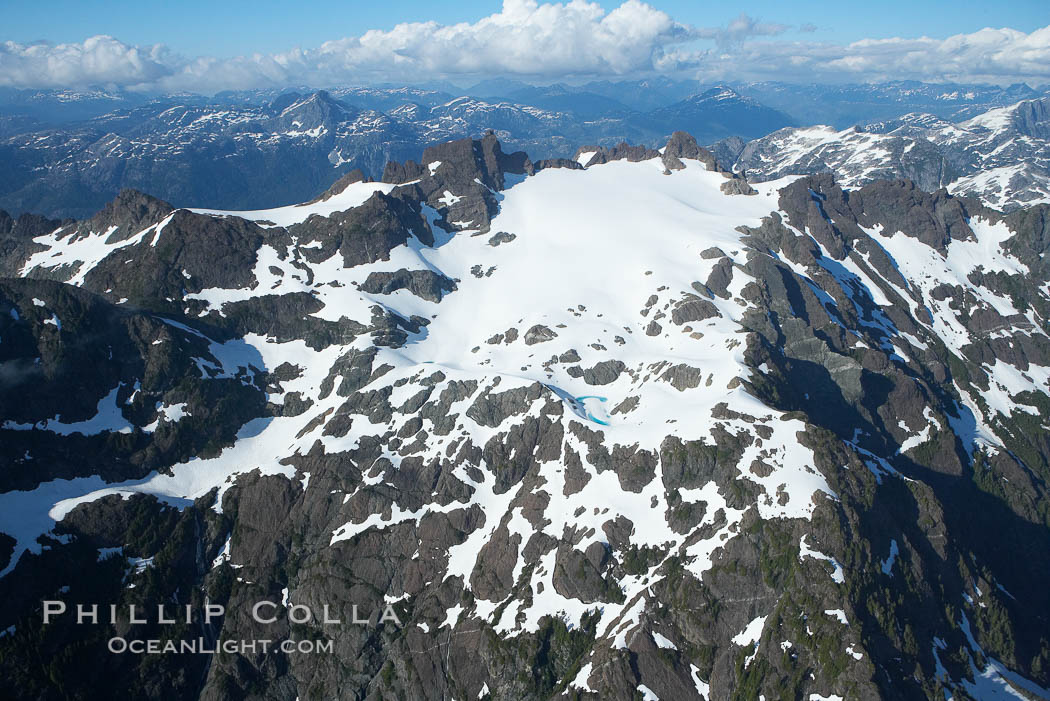 Mariner Mountain, on the west coast of Vancouver Island, British Columbia, Canada, part of Strathcona Provincial Park, located 36 km (22 mi) north of Tofino.  It is 1,771 m (5,810 ft) high, snow covered year-round and home to several glaciers., natural history stock photograph, photo id 21123