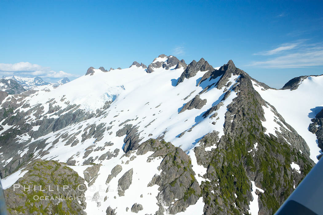 Mariner Mountain, viewed from the northwest, on the west coast of Vancouver Island, British Columbia, Canada, part of Strathcona Provincial Park, located 36 km (22 mi) north of Tofino.  It is 1,771 m (5,810 ft) high, snow covered year-round and home to several glaciers., natural history stock photograph, photo id 21085