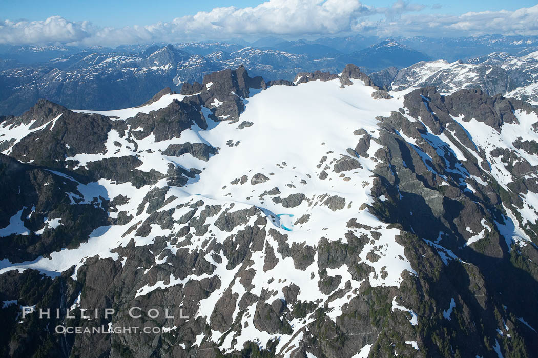 Mariner Mountain, on the west coast of Vancouver Island, British Columbia, Canada, part of Strathcona Provincial Park, located 36 km (22 mi) north of Tofino.  It is 1,771 m (5,810 ft) high, snow covered year-round and home to several glaciers., natural history stock photograph, photo id 21089