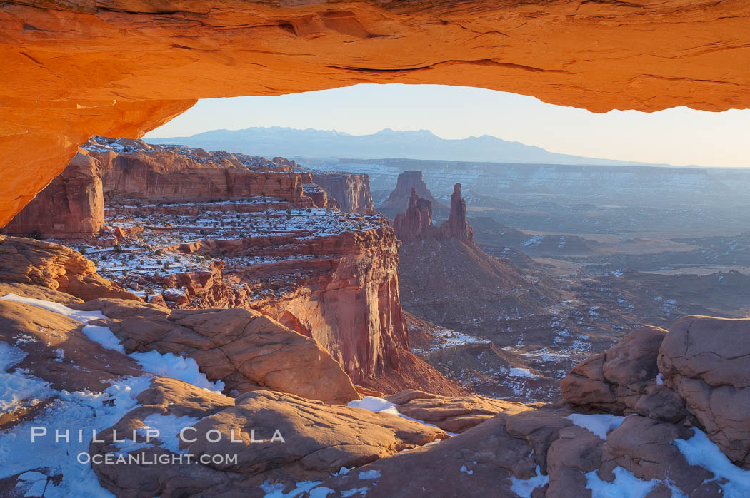 Mesa Arch spans 90 feet and stands at the edge of a mesa precipice thousands of feet above the Colorado River gorge. For a few moments at sunrise the underside of the arch glows dramatically red and orange. Island in the Sky, Canyonlands National Park, Utah, USA, natural history stock photograph, photo id 18078