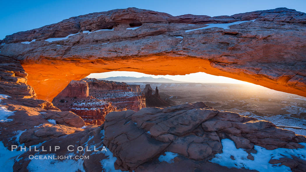 Mesa Arch spans 90 feet and stands at the edge of a mesa precipice thousands of feet above the Colorado River gorge. For a few moments at sunrise the underside of the arch glows dramatically red and orange. Island in the Sky, Canyonlands National Park, Utah, USA, natural history stock photograph, photo id 18040