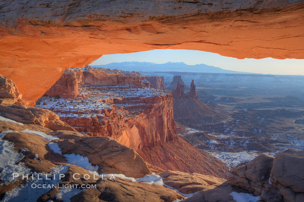 Mesa Arch spans 90 feet and stands at the edge of a mesa precipice thousands of feet above the Colorado River gorge. For a few moments at sunrise the underside of the arch glows dramatically red and orange. Island in the Sky, Canyonlands National Park, Utah, USA, natural history stock photograph, photo id 18080