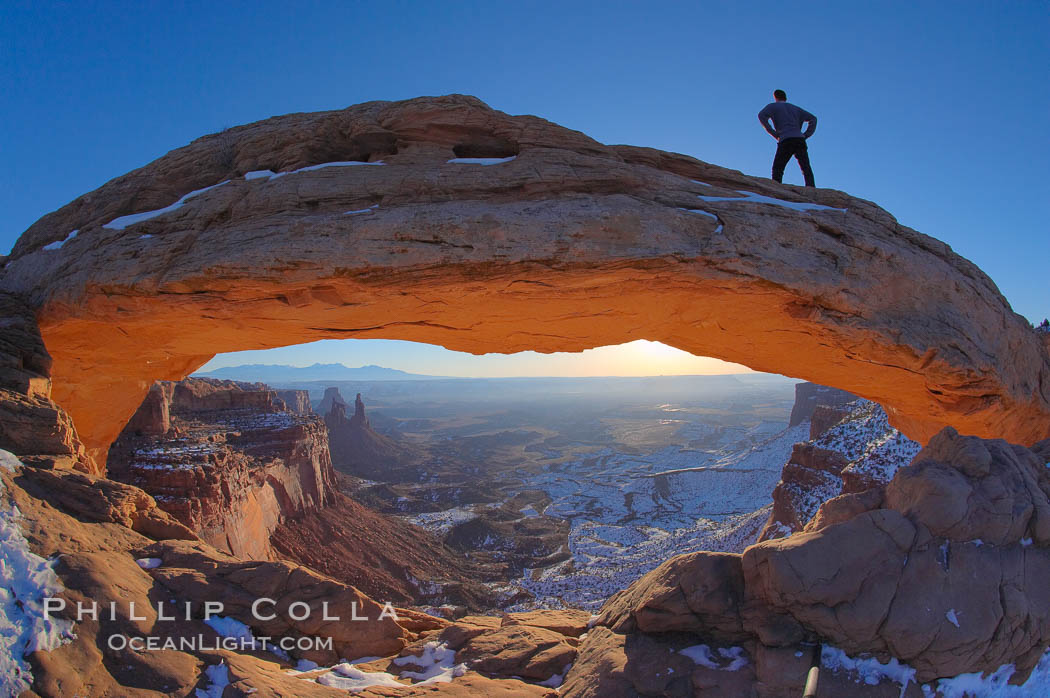 Mesa Arch, Utah.  An hiker watches the dawning sun from atop Mesa Arch. Island in the Sky, Canyonlands National Park, USA, natural history stock photograph, photo id 18084