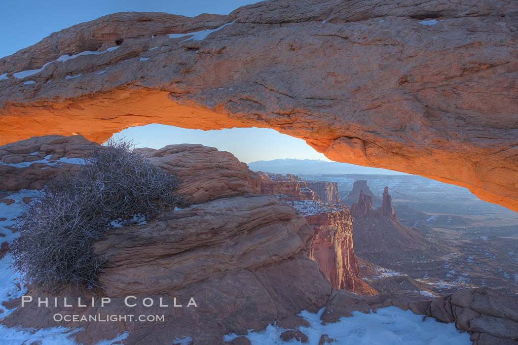 Mesa Arch spans 90 feet and stands at the edge of a mesa precipice thousands of feet above the Colorado River gorge. For a few moments at sunrise the underside of the arch glows dramatically red and orange. Island in the Sky, Canyonlands National Park, Utah, USA, natural history stock photograph, photo id 18079