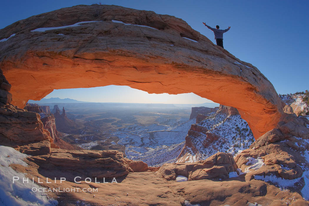 Extended High Mountain pose, Utthita Tadasana, at dawn on Mesa Arch, Utah.  An exuberant hiker greets the dawning sun from atop Mesa Arch. Island in the Sky, Canyonlands National Park, USA, natural history stock photograph, photo id 18083