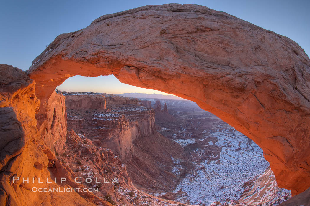 Mesa Arch spans 90 feet and stands at the edge of a mesa precipice thousands of feet above the Colorado River gorge. For a few moments at sunrise the underside of the arch glows dramatically red and orange. Island in the Sky, Canyonlands National Park, Utah, USA, natural history stock photograph, photo id 18077