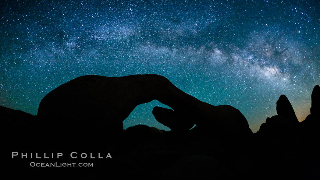 The Milky Way galaxy arches over Arch Rock on a clear evening in Joshua Tree National Park. California, USA, natural history stock photograph, photo id 26798
