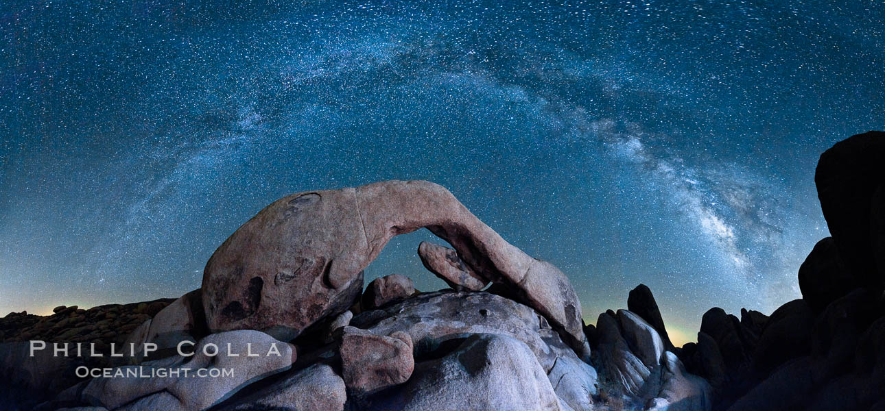 The Milky Way galaxy arcs above Arch Rock, panoramic photograph, cylindrical projection. Joshua Tree National Park, California, USA, natural history stock photograph, photo id 26850