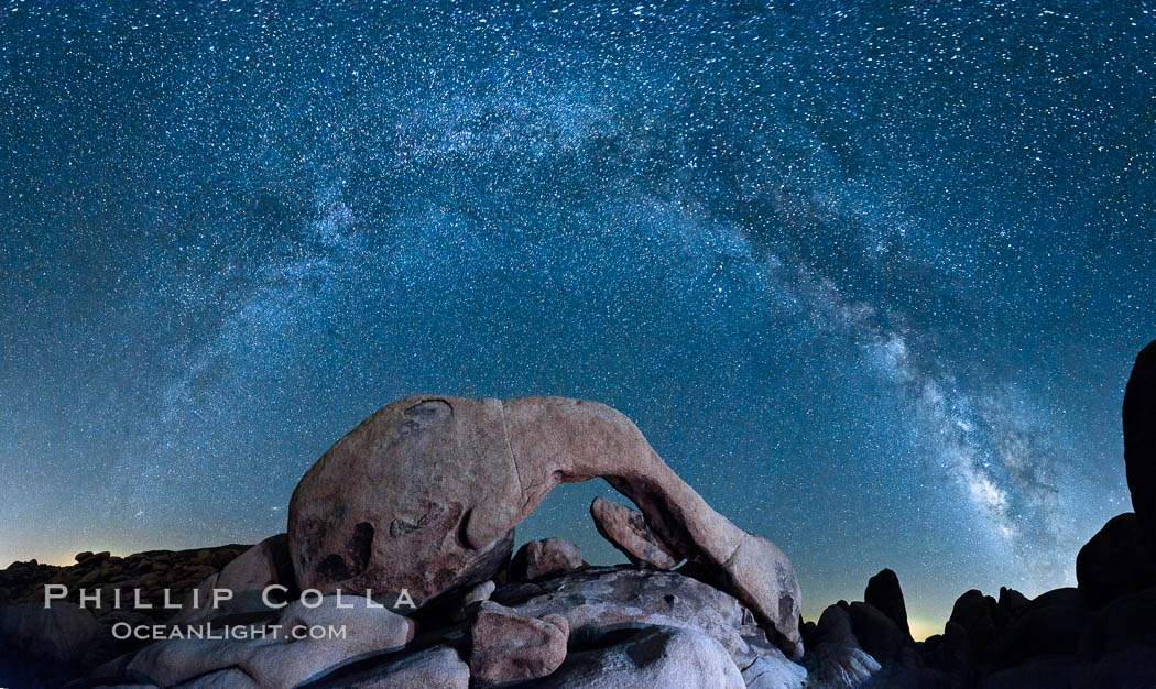 The Milky Way galaxy arcs above Arch Rock, panoramic photograph, cylindrical projection. Joshua Tree National Park, California, USA, natural history stock photograph, photo id 26848