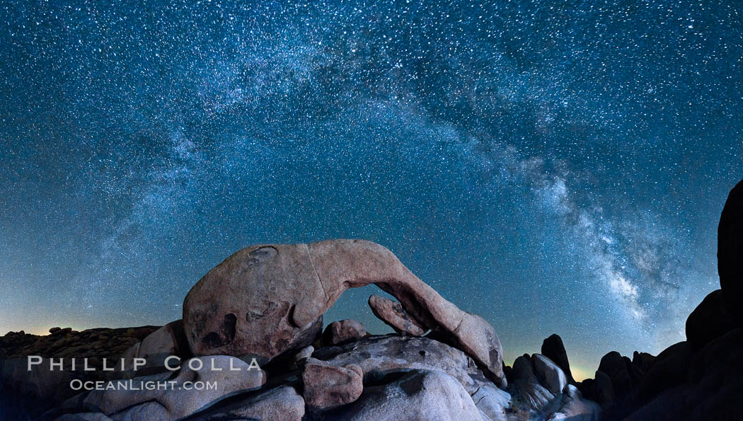 The Milky Way galaxy arcs above Arch Rock, panoramic photograph, cylindrical projection. Joshua Tree National Park, California, USA, natural history stock photograph, photo id 26849