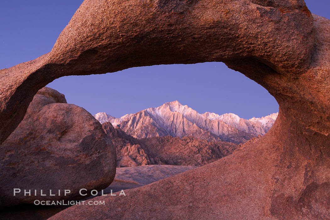 Mobius Arch at sunrise, framing snow dusted Lone Pine Peak and the Sierra Nevada Range in the background.  Also known as Galen's Arch, Mobius Arch is found in the Alabama Hills Recreational Area near Lone Pine. California, USA, natural history stock photograph, photo id 21736