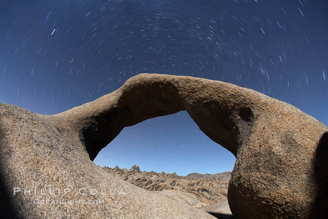 Mobius Arch in the Alabama Hills, seen here at night with swirling star trails formed in the sky above due to a long time exposure. Alabama Hills Recreational Area, California, USA, natural history stock photograph, photo id 21744