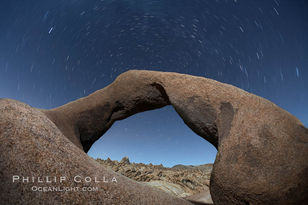 Mobius Arch in the Alabama Hills, seen here at night with swirling star trails formed in the sky above due to a long time exposure. Alabama Hills Recreational Area, California, USA, natural history stock photograph, photo id 21772