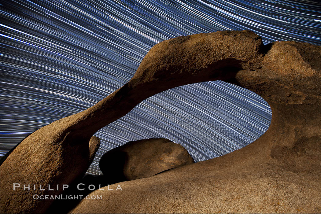 Mobius Arch in the Alabama Hills, seen here at night with swirling star trails formed in the sky above due to a long time exposure. Alabama Hills Recreational Area, California, USA, natural history stock photograph, photo id 27676