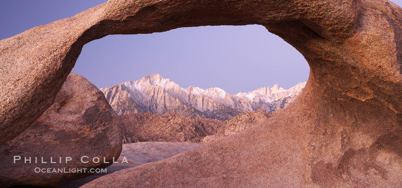 Image 21743, Mobius Arch at sunrise, framing snow dusted Lone Pine Peak and the Sierra Nevada Range in the background.  Also known as Galen's Arch, Mobius Arch is found in the Alabama Hills Recreational Area near Lone Pine. California, USA, Phillip Colla, all rights reserved worldwide.   Keywords: alabama hills:alabama hills arch:alabama hills recreational area:arch:bureau of land management:california:environment:galen arch:galen's arch:geologic features:geology:landscape:lone pine:mobius arch:moebius arch:movie road arch:natural arch:natural arches:nature:outdoors:outside:scene:scenery:scenic:usa:lone pine peak:sierra nevada.