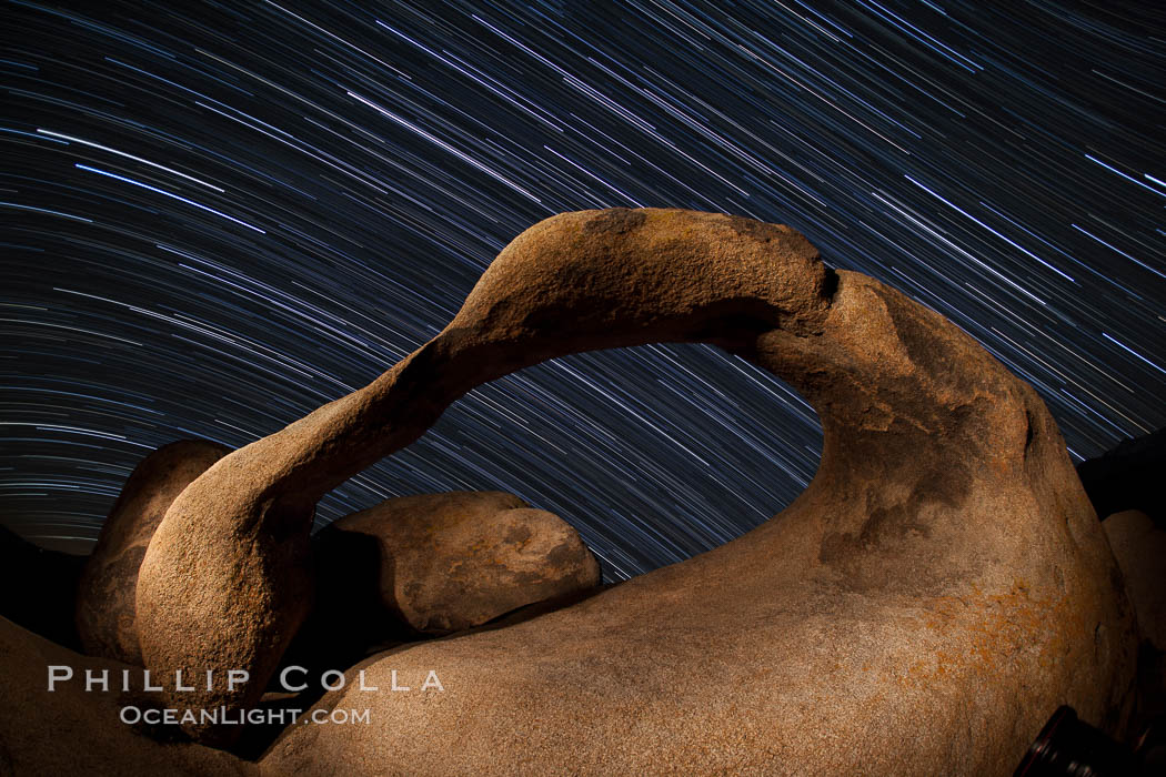 Mobius Arch in the Alabama Hills, seen here at night with swirling star trails formed in the sky above due to a long time exposure. Alabama Hills Recreational Area, California, USA, natural history stock photograph, photo id 27679