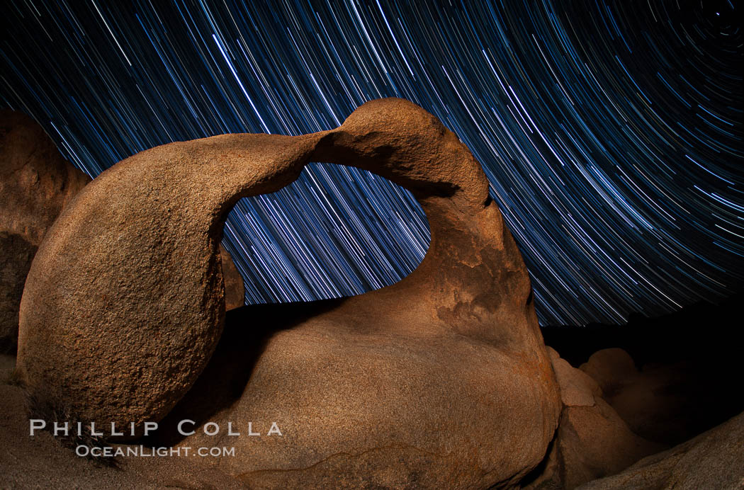 Mobius Arch in the Alabama Hills, seen here at night with swirling star trails formed in the sky above due to a long time exposure. Polaris, the North Star, is visible at upper right. Alabama Hills Recreational Area, California, USA, natural history stock photograph, photo id 27677