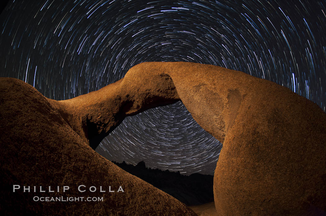 Mobius Arch in the Alabama Hills, seen here at night with swirling star trails formed in the sky above due to a long time exposure. Alabama Hills Recreational Area, California, USA, natural history stock photograph, photo id 27681