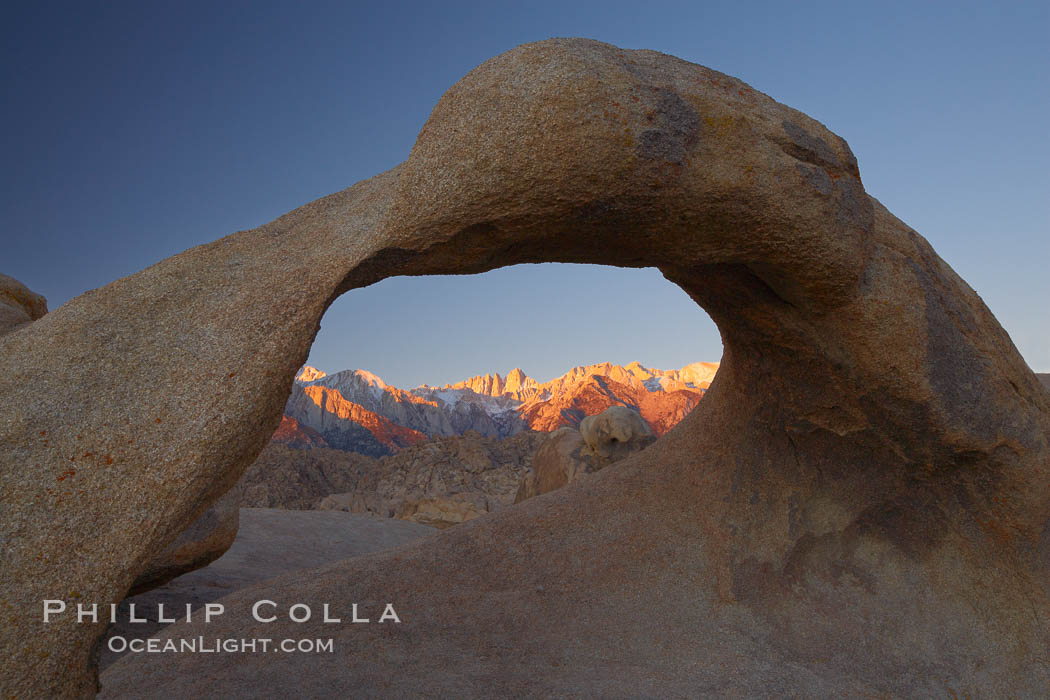 Mobius Arch, with snow covered Mt. Whitney and the Sierra Nevada Range framed within the natural stone arch.  Mt. Whitney is the highest peak in the continental United States. Alabama Hills Recreational Area, California, USA, natural history stock photograph, photo id 21756