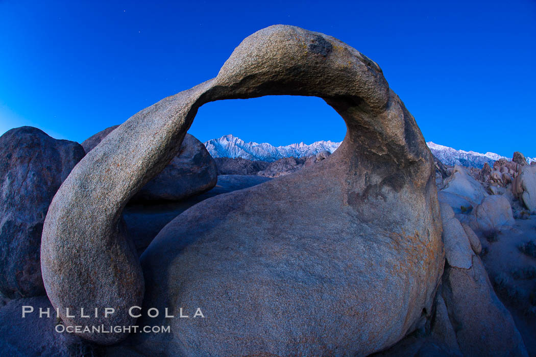 Mobius Arch at sunrise, framing snow dusted Lone Pine Peak and the Sierra Nevada Range in the background. Also known as Galen's Arch, Mobius Arch is found in the Alabama Hills Recreational Area near Lone Pine. California, USA, natural history stock photograph, photo id 27626