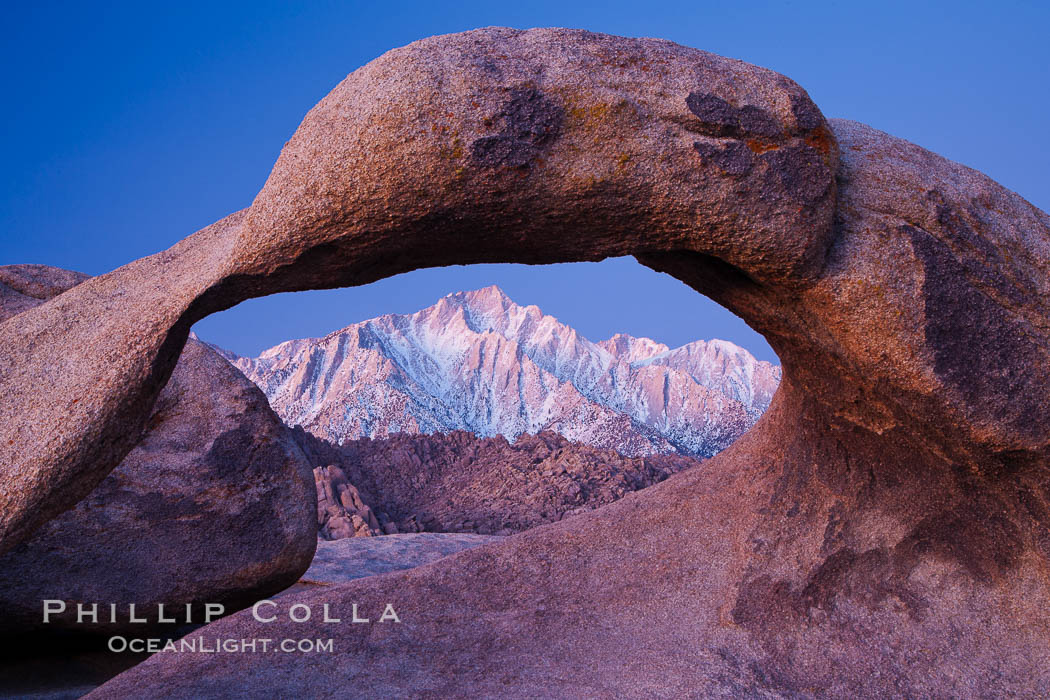 Mobius Arch at sunrise, framing snow dusted Lone Pine Peak and the Sierra Nevada Range in the background. Also known as Galen's Arch, Mobius Arch is found in the Alabama Hills Recreational Area near Lone Pine. California, USA, natural history stock photograph, photo id 27627