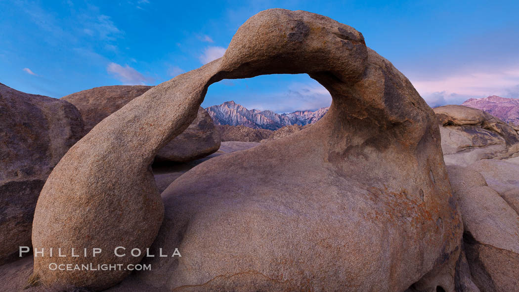 Mobius Arch at sunrise, framing snow dusted Lone Pine Peak and the Sierra Nevada Range in the background. Also known as Galen's Arch, Mobius Arch is found in the Alabama Hills Recreational Area near Lone Pine. California, USA, natural history stock photograph, photo id 27647