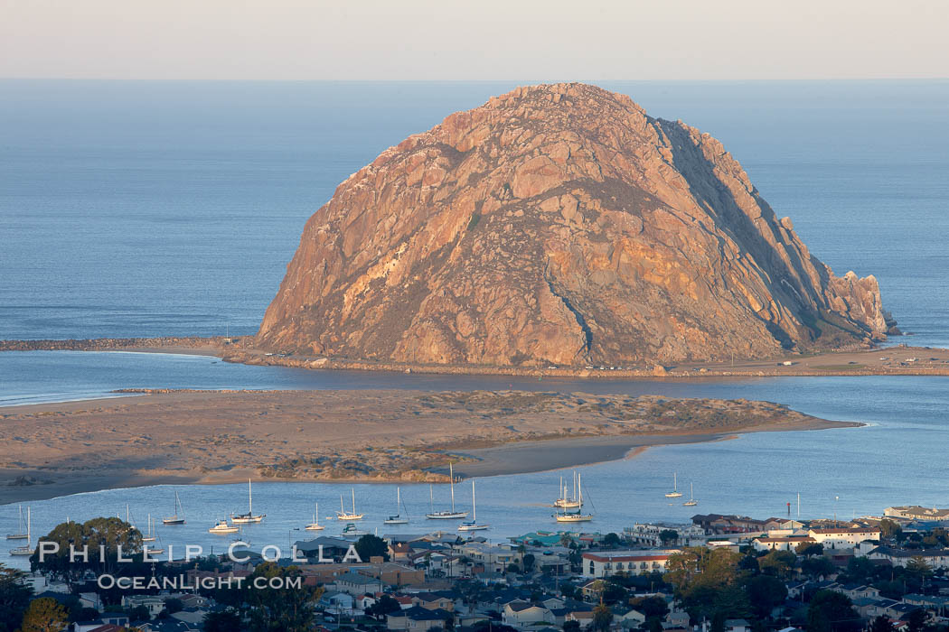 Morro Rock lit at sunrise, rises above Morro Bay which is still in early morning shadow. California, USA, natural history stock photograph, photo id 22223