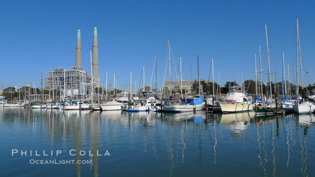 Moss Landing Power Plant rise above Moss Landing harbor and Elkhorn Slough.  The Moss Landing Power Plant is an electricity generation plant at Moss Landing, California.  The twin stacks, each 500 feet high, mark two generation units product 750 megawatts each., natural history stock photograph, photo id 21506