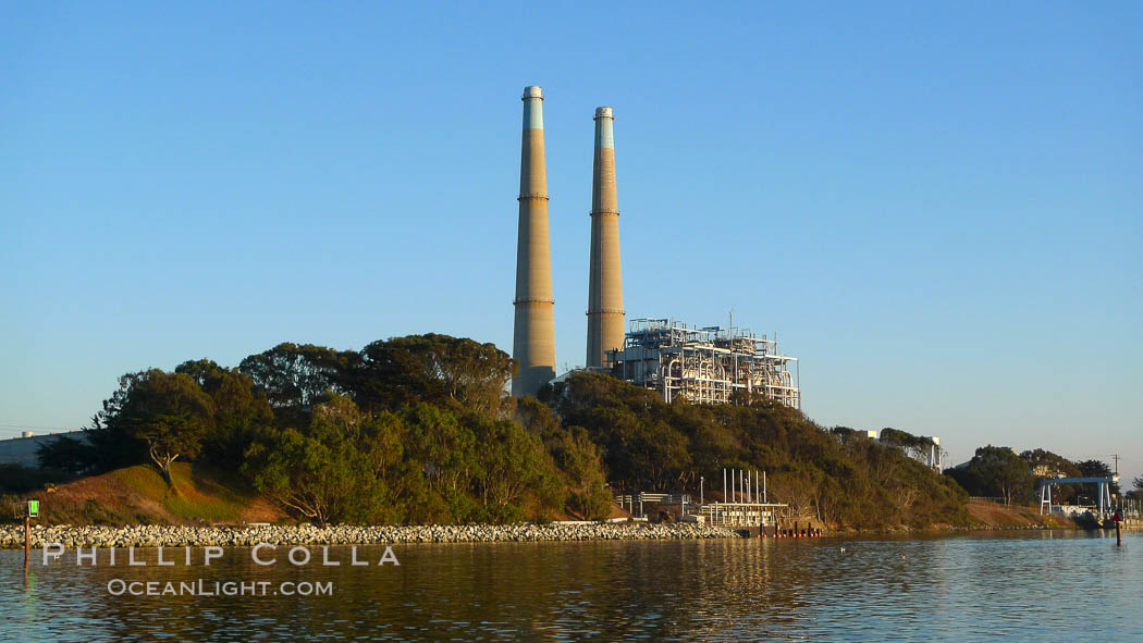 Moss Landing Power Plant rise above Moss Landing harbor and Elkhorn Slough.  The Moss Landing Power Plant is an electricity generation plant at Moss Landing, California.  The twin stacks, each 500 feet high, mark two generation units product 750 megawatts each. USA, natural history stock photograph, photo id 21496