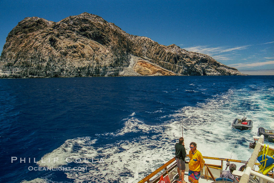 Motoring across Melpomene Cove, south end of Guadalupe Island, Mexico. Dragging fishing lines for tuna or yellowtail until we get to our dive site. Guadalupe Island (Isla Guadalupe), Baja California, natural history stock photograph, photo id 36231
