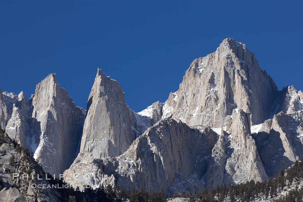 Mt. Whitney is the highest point in the contiguous United States with an elevation of 14,505 feet (4,421 m).  It lies along the crest of the Sierra Nevada mountain range.  Composed of the Sierra Nevada batholith granite formation, its eastern side (seen here) is quite steep.  It is climbed by hundreds of hikers each year., natural history stock photograph, photo id 21760