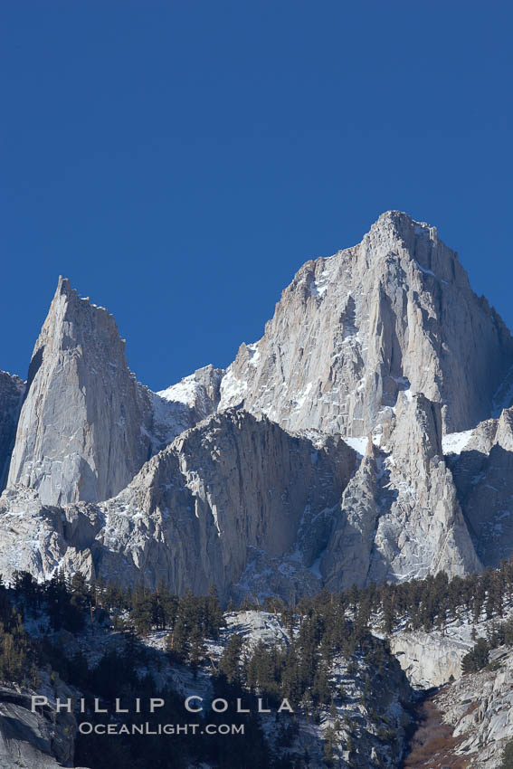 Mt. Whitney is the highest point in the contiguous United States with an elevation of 14,505 feet (4,421 m).  It lies along the crest of the Sierra Nevada mountain range.  Composed of the Sierra Nevada batholith granite formation, its eastern side (seen here) is quite steep.  It is climbed by hundreds of hikers each year., natural history stock photograph, photo id 21771