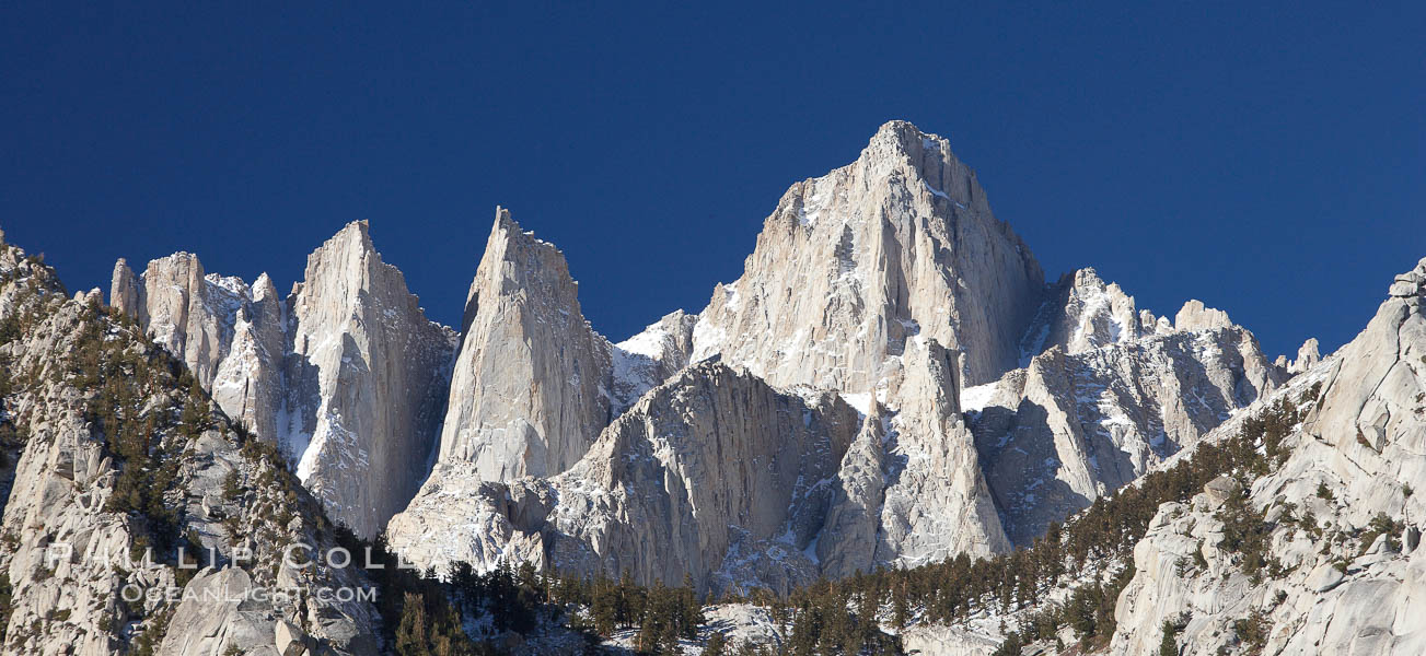 Mt. Whitney is the highest point in the contiguous United States with an elevation of 14,505 feet (4,421 m).  It lies along the crest of the Sierra Nevada mountain range.  Composed of the Sierra Nevada batholith granite formation, its eastern side (seen here) is quite steep.  It is climbed by hundreds of hikers each year., natural history stock photograph, photo id 21761