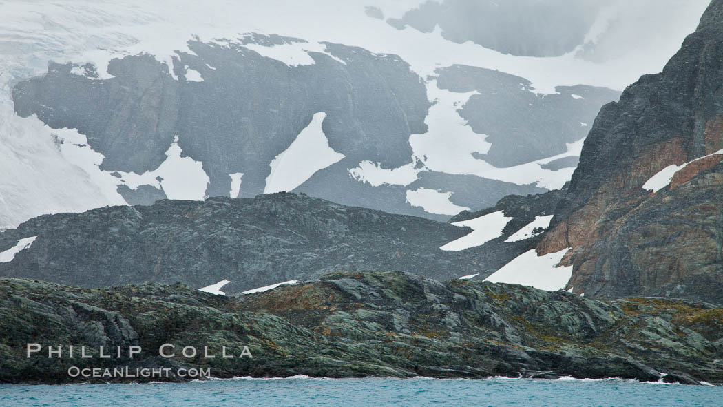 Mountainsides, rocky and snow covered, overlooking Drygalski Fjord. South Georgia Island, natural history stock photograph, photo id 24714