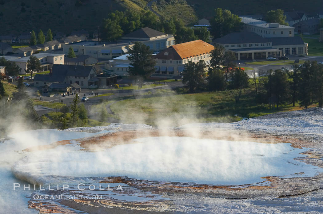 New Blue Spring steams in the cold morning air with Mammoth Hot Springs Inn in the distance. Yellowstone National Park, Wyoming, USA, natural history stock photograph, photo id 13610