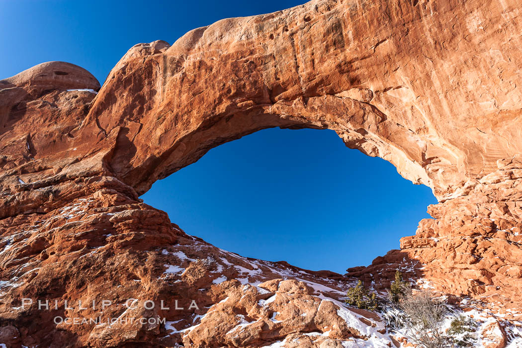 North Window, sunrise, eastern face.  North Window is a natural sandstone arch 90 feet wide and 48 feet high. Arches National Park, Utah, USA, natural history stock photograph, photo id 18166