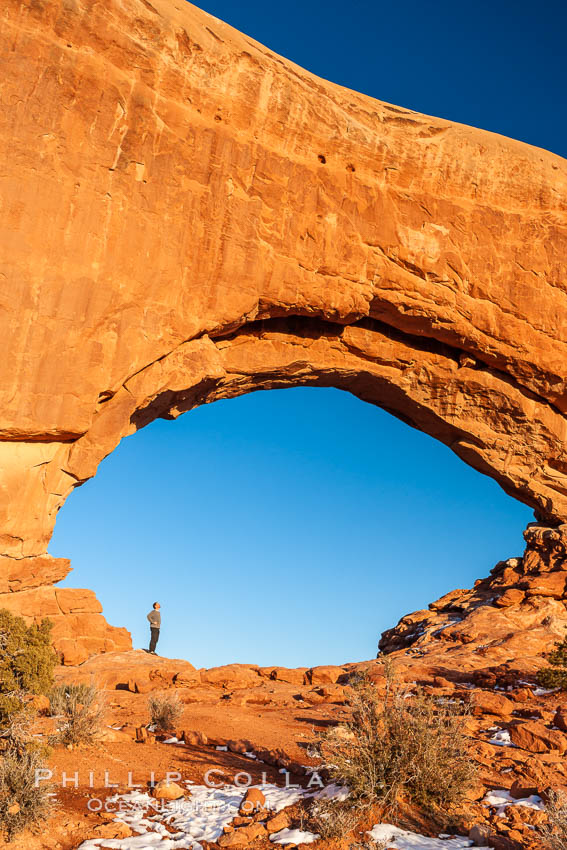 Hiker in North Window, sunset, western face.  North Window is a natural sandstone arch 90 feet wide and 48 feet high. Arches National Park, Utah, USA, natural history stock photograph, photo id 18168
