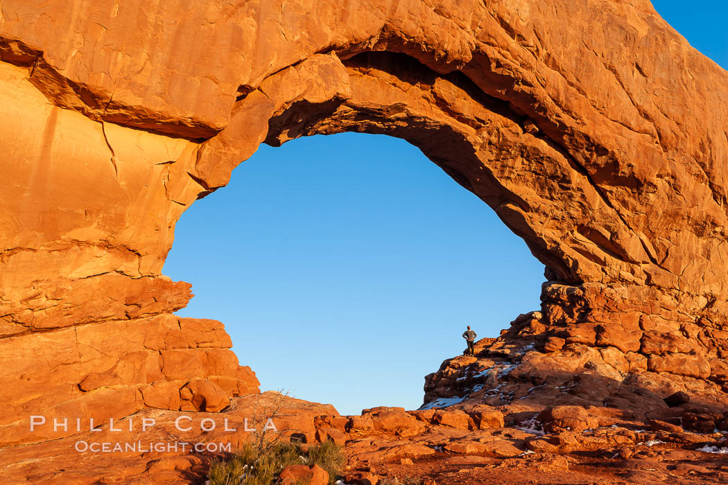 Hiker in North Window, sunset, western face.  North Window is a natural sandstone arch 90 feet wide and 48 feet high. Arches National Park, Utah, USA, natural history stock photograph, photo id 18167