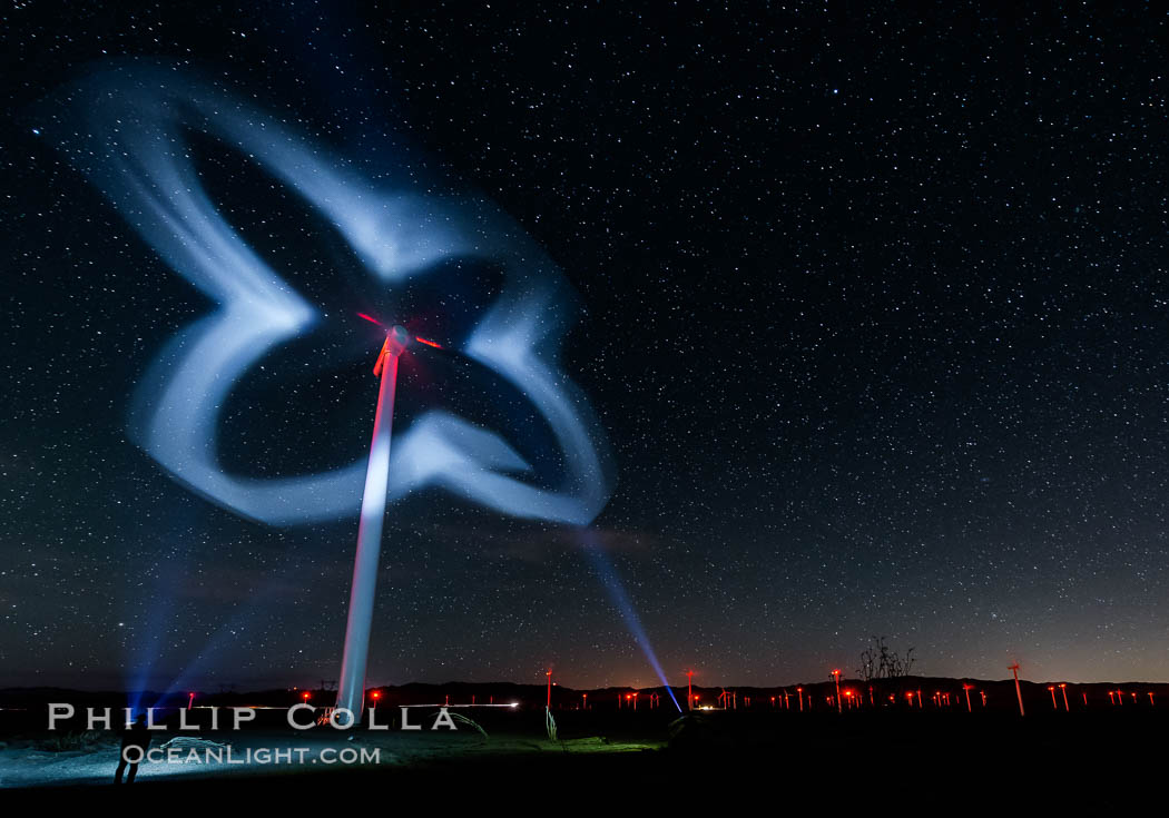 Stars rise above the Ocotillo Wind Turbine power generation facility, with a flashlight illuminating the turning turbine blades. California, USA, natural history stock photograph, photo id 30228