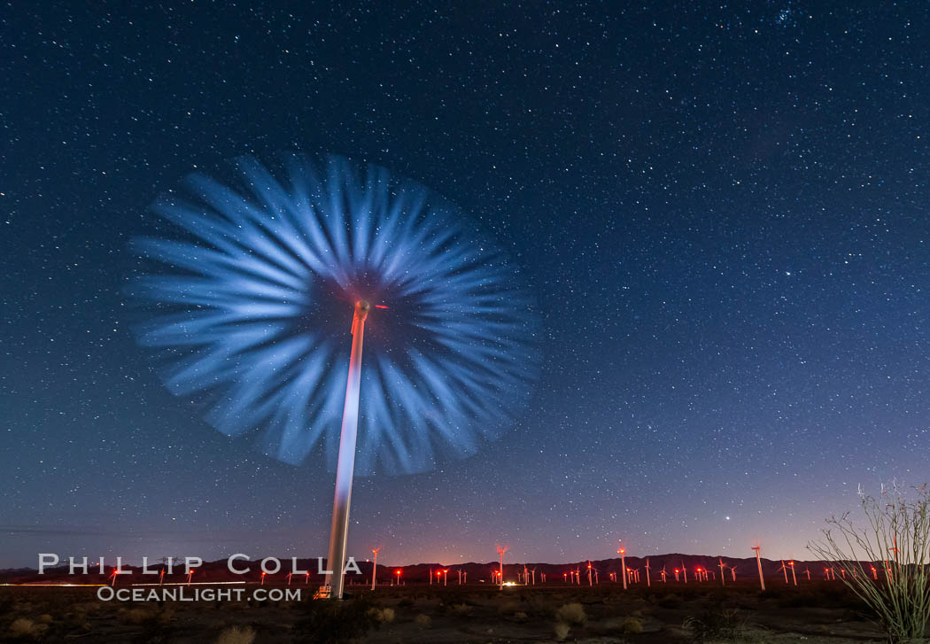 Stars rise above the Ocotillo Wind Turbine power generation facility, with a flashlight illuminating the turning turbine blades., natural history stock photograph, photo id 30223