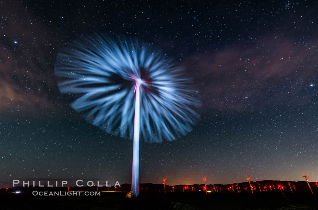 Stars rise above the Ocotillo Wind Turbine power generation facility, with a flashlight illuminating the turning turbine blades. California, USA, natural history stock photograph, photo id 30225
