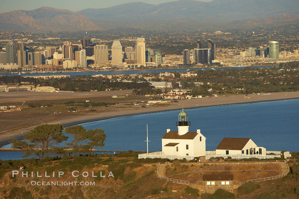 Old Point Loma Lighthouse, sitting high atop the end of Point Loma peninsula, seen here with San Diego Bay and downtown San Diego in the distance.  The old Point Loma lighthouse operated from 1855 to 1891 above the entrance to San Diego Bay. It is now a maintained by the National Park Service and is part of Cabrillo National Monument. California, USA, natural history stock photograph, photo id 22409