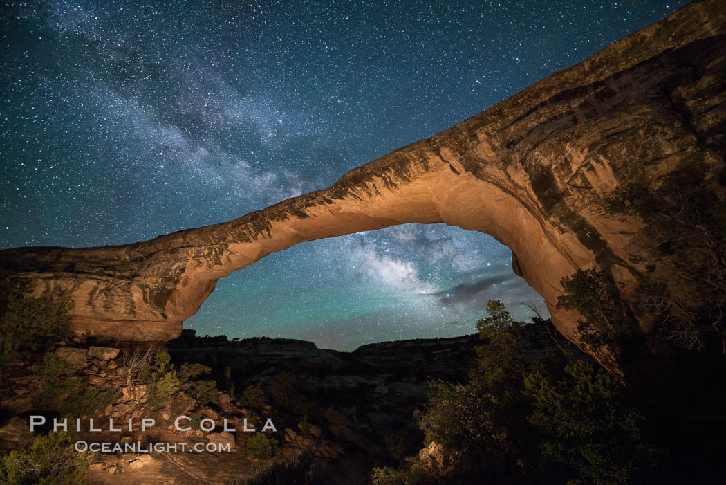 Owachomo Bridge and Milky Way.  Owachomo Bridge, a natural stone bridge standing 106' high and spanning 130' wide,stretches across a canyon with the Milky Way crossing the night sky. Natural Bridges National Monument, Utah, USA, natural history stock photograph, photo id 28542