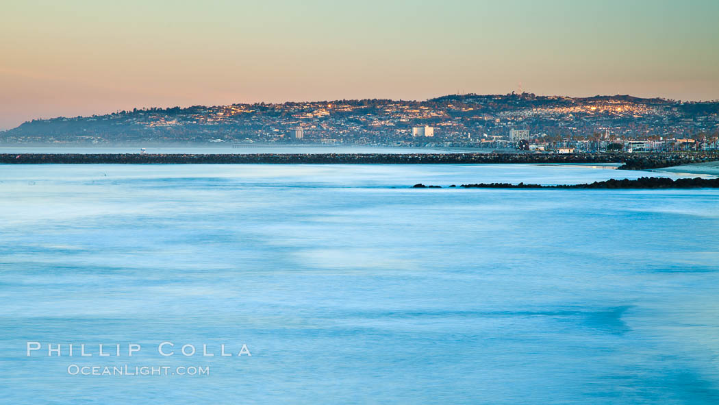 Pacific Beach and La Jolla and Mount Soledad at dawn, viewed over breaking waves from the Ocean Beach Pier., natural history stock photograph, photo id 27393