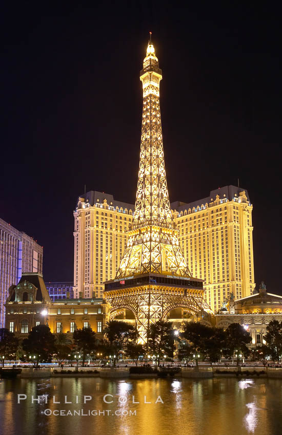 The half-scale replica of the Eiffel Tower at the Paris Hotel in Las Vegas is reflected in the Bellagio Hotel fountain pool at night. Nevada, USA, natural history stock photograph, photo id 20578