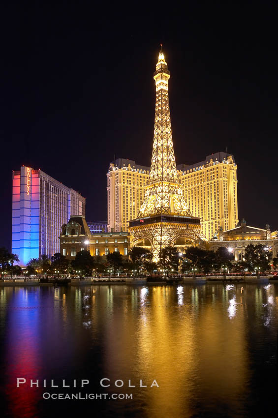 The Bellagio Hotel fountains light up the reflection pool as the half-scale replica of the Eiffel Tower at the Paris Hotel in Las Vegas rises above them, at night. Nevada, USA, natural history stock photograph, photo id 20564